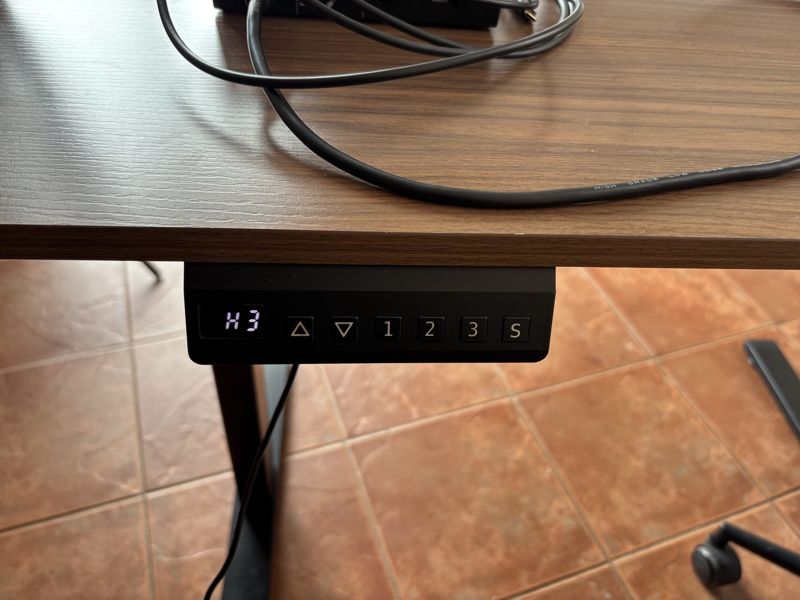 Control panel under the desk with up and down buttons and three memory presets