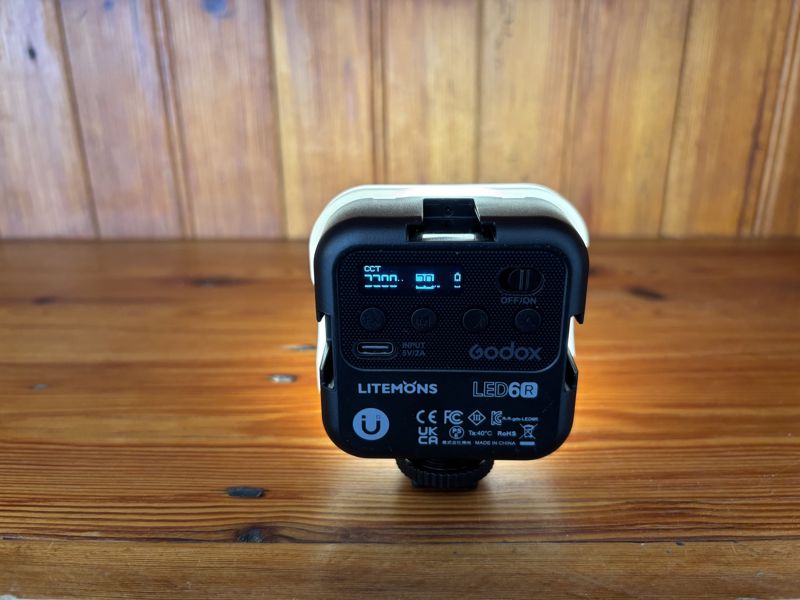 Godox Litemons LED6R light glowing white on a pine shelf